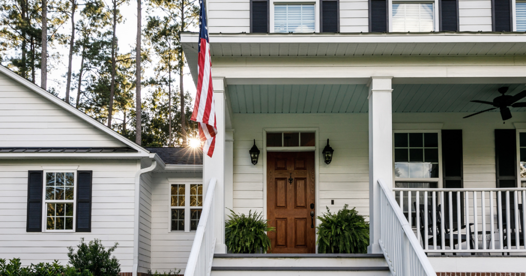 exterior of a two-story home with garage and US flag