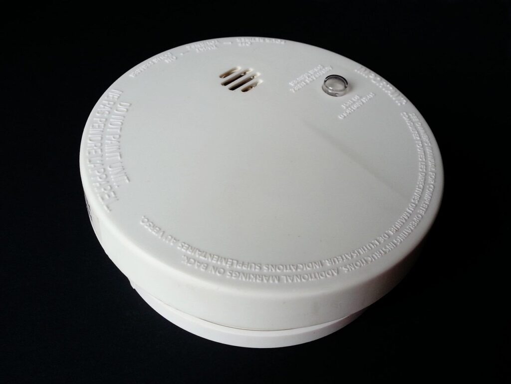 Close-up of a white ceiling-mounted home safety alarm